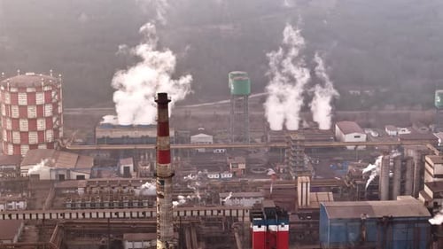 Wide Angle Drone View of an Industrial Plant with Smoking Factory Chimneys