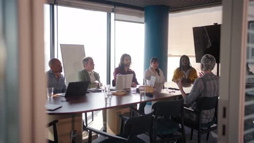 Diverse Business Team Engaging in Collaborative Discussion in Modern Office