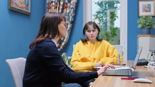 Teenage Girl College Student Talking with Counselor Psychologist in Office