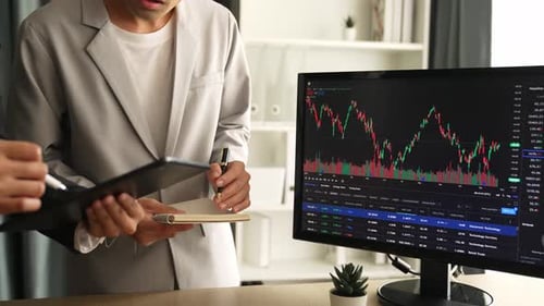 Financial Analysts Discussing Stock Market Trends in Office