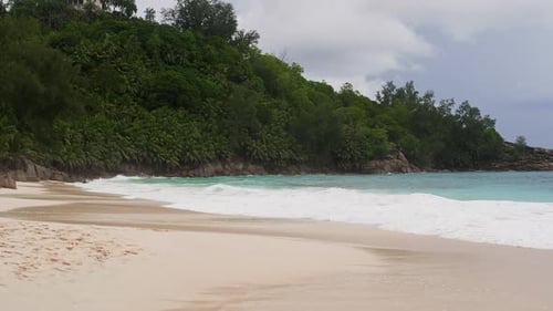 Pristine Tropical Beach with Turquoise Waves Crashing on White Sand Paradise