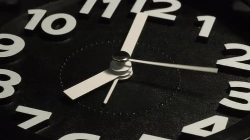 Tme lapse video of a clock time passing over a day to night on black background.