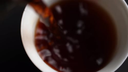 Pouring Dark Liquid into White Bowl Close Up