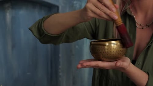 Woman Plays a Tibetan Singing Bowl