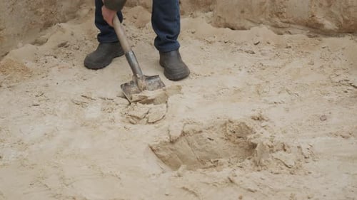 Digging in Soft Sand for Construction Project During Sunny Day