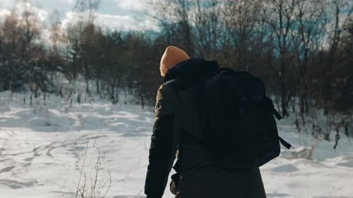 Wanderlust Journey Backpacker Walking Winter Trek in Back View