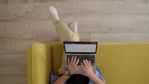 Top Down View of Sofa on Which Man Sits Down with Laptop and Work Unrecognizable Bald Freelancer