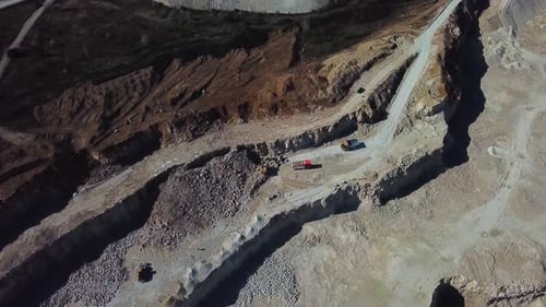 Excavator Loads a Dump Truck with Soil The Excavator Digs the Ground at the Construction Site