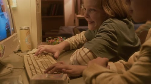 Children Playing Retro Computer Game at Home