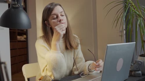 Woman Taking Off Glasses and Rubbing Eyes in Office