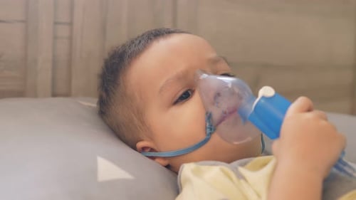 Young Child Using Nebulizer at Home