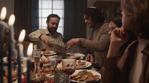 Family Celebrates Holiday Meal with Festive Candles