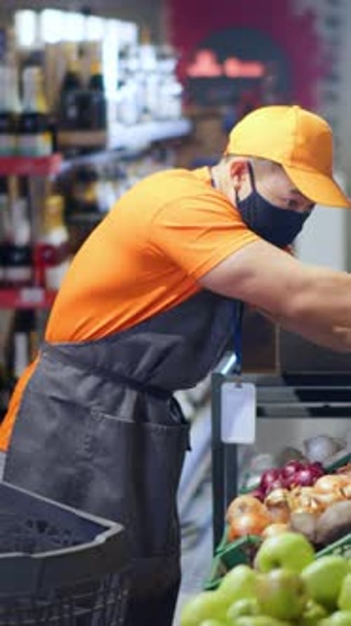 Asian Busy Shop Assistant Arranging Foods on Shelves Collecting Lettuce in Grocery Store Chinese