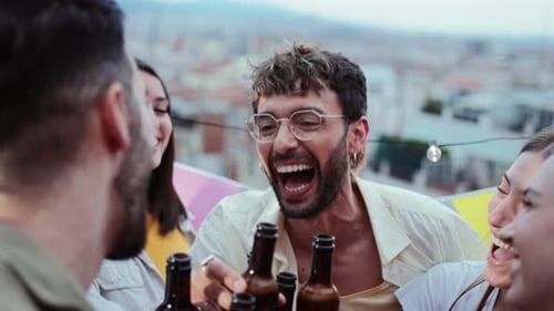 Friends Toasting with Beer on Urban Rooftop