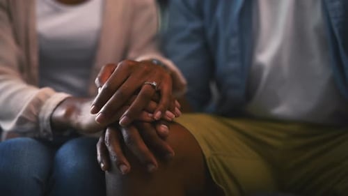 Couple Holds Hands in Loving Close Up Indoors