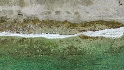 Aerial View Solitary Steps Man in Black's Meditative Beach Walk