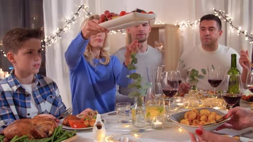 Family sharing a holiday meal at home at night