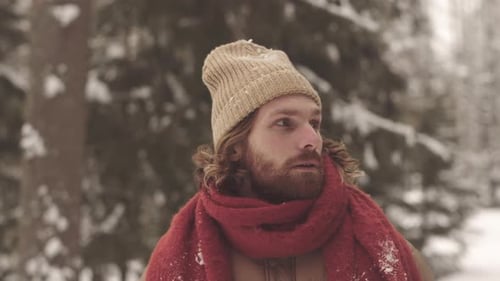 Smiling Bearded Man in a Snow Covered Forest