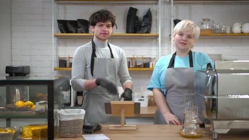 Confident Young Caucasian Barista and Waiter Crossing Hands Looking at Camera Smiling Portrait of