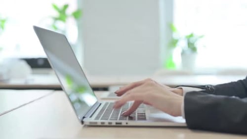 Side View of Female Hands Typing on Laptop