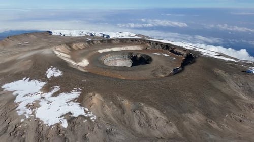 Aerial shot of Uhuru Peak overlooking Kilimanjaro’s massive volcanic crater.