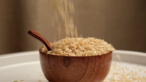 Dry Rice in Wooden Bowl Long Brown Rice Rotating Close Up Grains Fall Poured a Stack World Crisis