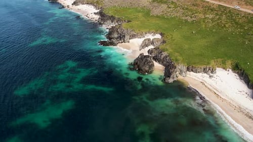Aerial view of wild rocky cliffs along the coastline in Iceland.