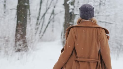 Happy Woman Enjoys a Walk in Winter Park