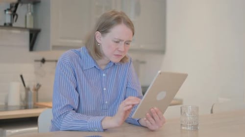 Woman Cries While Using Tablet at Home