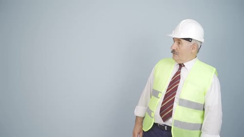 Engineer looking at camera in amazement and making a presentation.