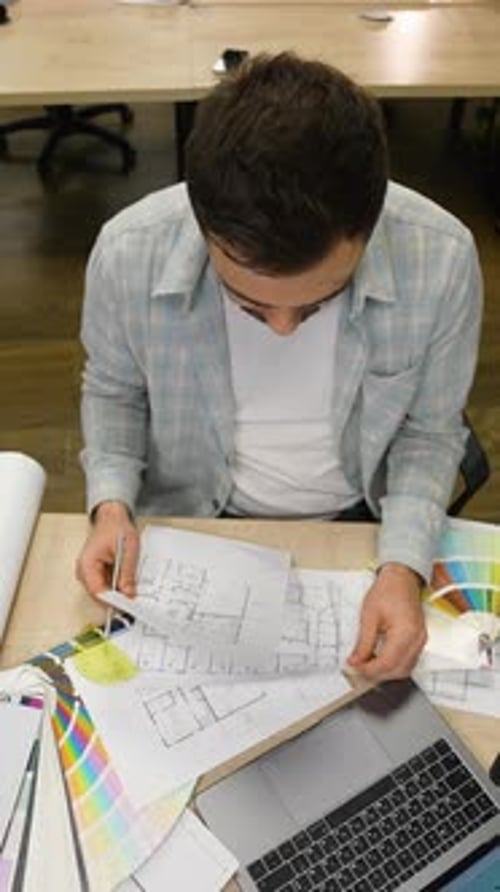 Professional Architect Drawing Blueprint at Office Desk