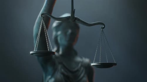 Filmmusik und atmosphärische Nahaufnahme von Waagen, die Lady Justice in der Hand hält.