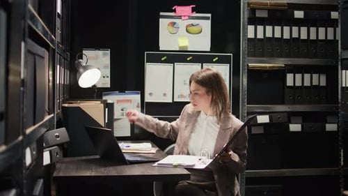 Woman Works at Desk in Small Office
