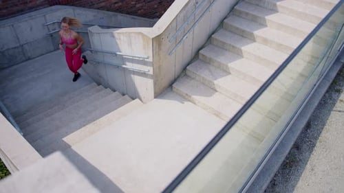 Blonde Woman Running Up Concrete Urban Staircase Outdoors