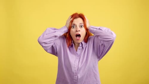 Woman Reacting in Shock on Yellow Background
