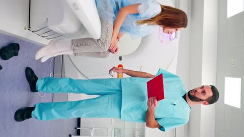 Patient Prepares for CT Scan With Medical Professional