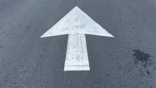 A painted arrow to show that the road is a one way street in a suburb of Cape Town, South Africa.