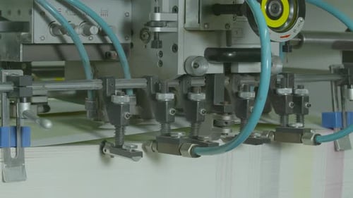 Equipment at paper processing factory making printed products, prints of posters, newspapers