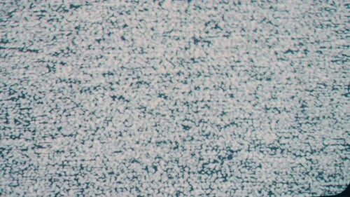 A close-up static shot capturing the iconic snow-like pattern of TV static noise. Perfect for themes