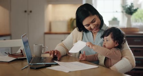Mother and Baby Working Together at Home