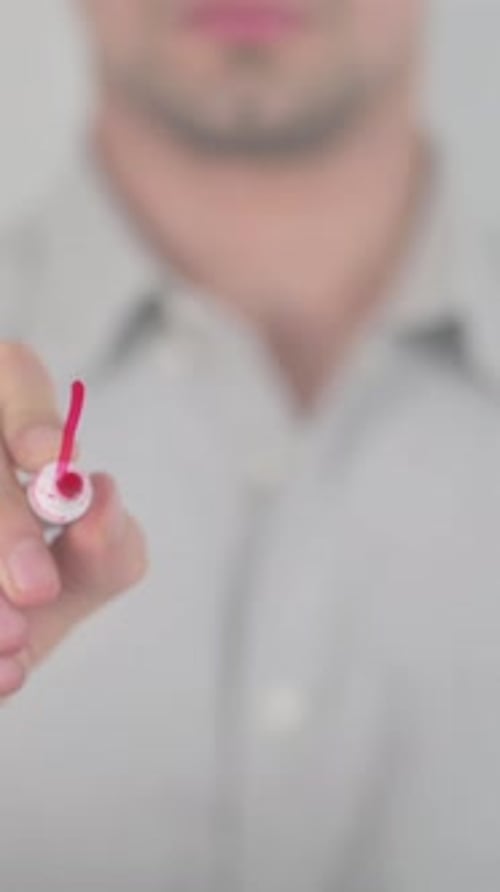 Man Writes 'Exit' on Glass with Red Marker