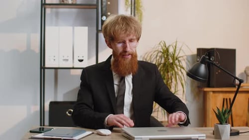 Young Business Man Freelancer at Office Start Working on Laptop Computer Sends Online Messages