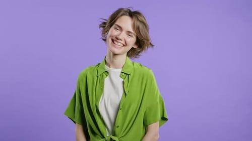 Happy Woman Smiling in Studio with Purple Background