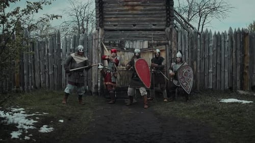Warriors Posing in Front of Wooden Gate