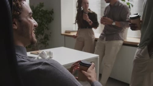 Coworkers Talking in an Office During Break