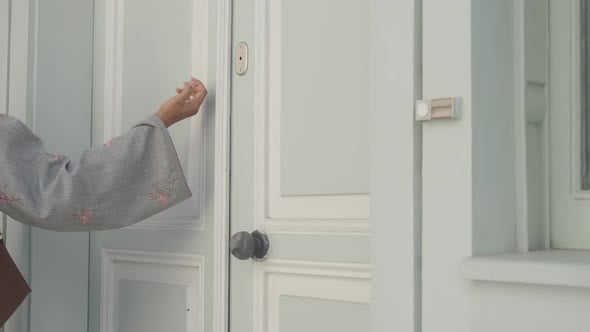 Hand Knocking on a Door in a Quiet Neighborhood Setting, Buildings ...
