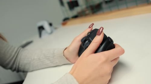 Close-up: A woman plays a console with a joystick or gamepad. Girl playing computer games