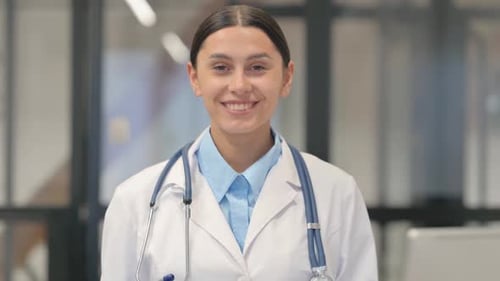 Smiling Young Adult Doctor in White Coat
