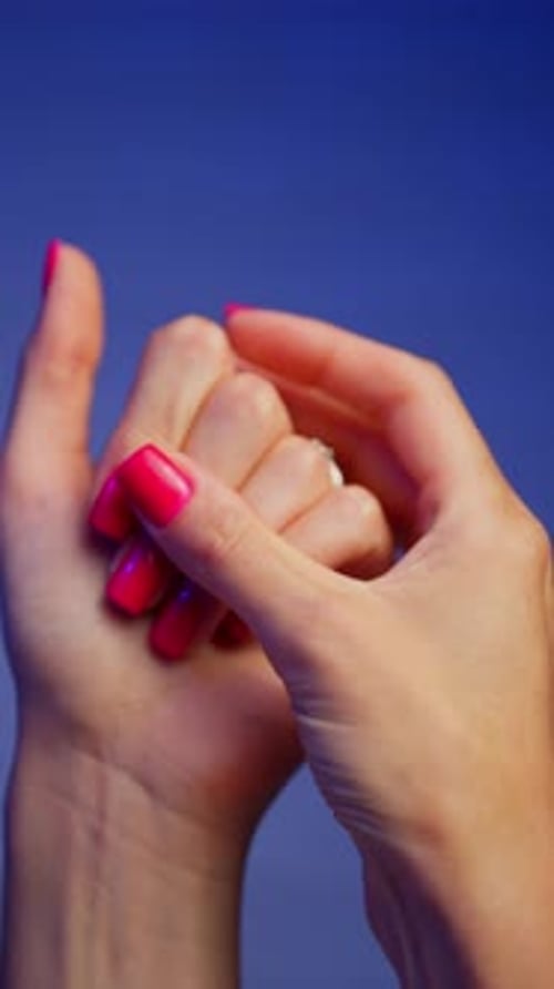 Woman Hands Massaging Pink Fingernails Close Up