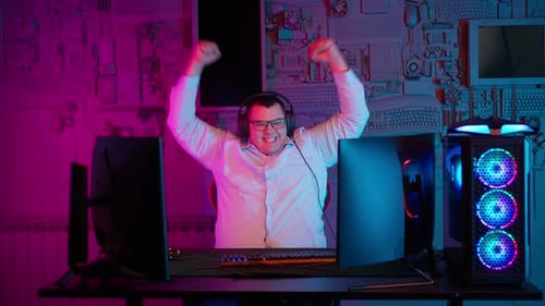 Excited Gamer Celebrates Success in Colorful Room